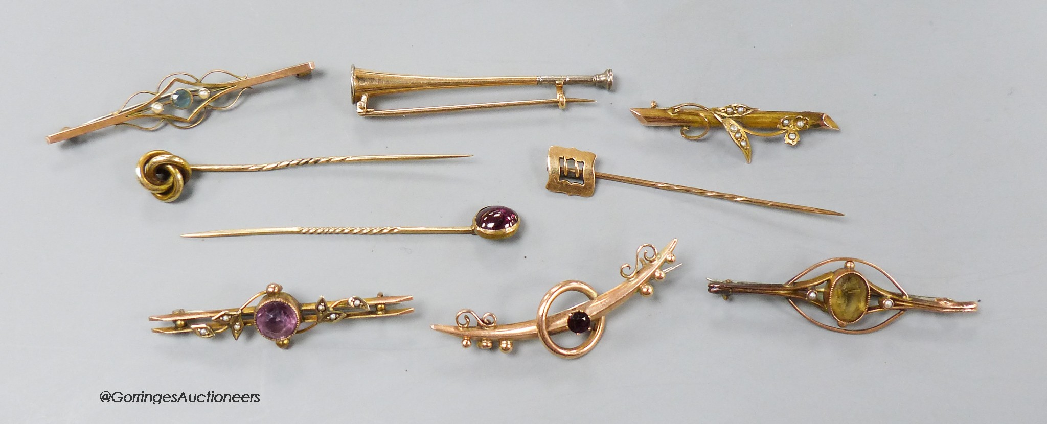 Four assorted early 20th century 9ct and gem set bar brooches, gross 9.1 grams, two yellow metal bar brooches including hunting horn and two yellow metal gem set stick pins, gross 10 grams and a 15ct stick pin, 1.4 grams